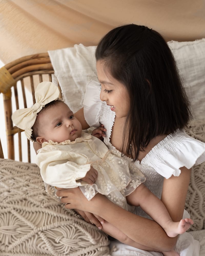 Mother holding baby with serene expression