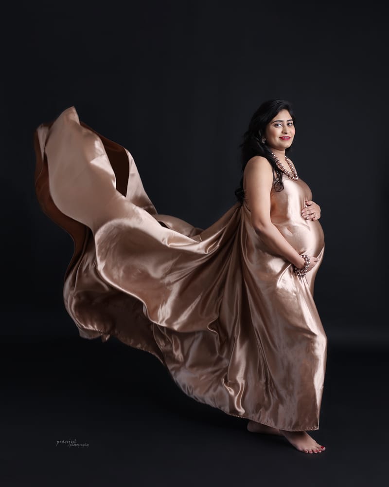 Elegant maternity portrait with floral setup