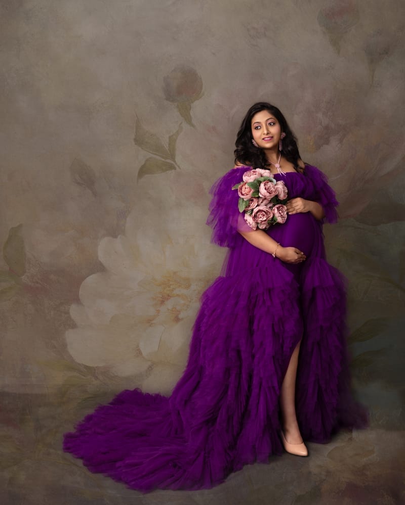 Artistic maternity portrait with dramatic lighting