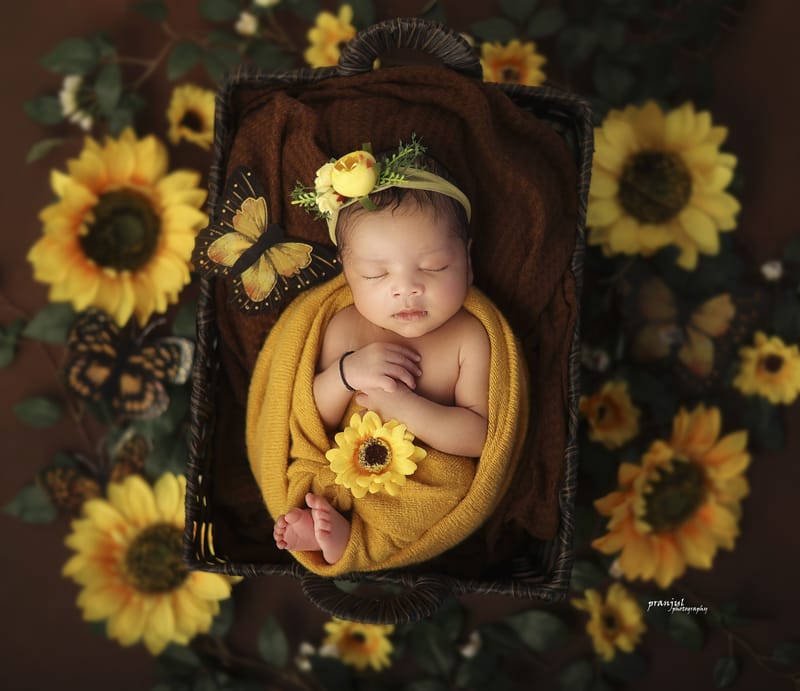 Sleeping newborn on a textured fabric backdrop
