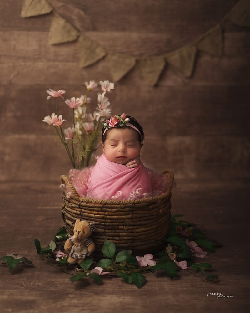 Newborn posed with delicate floral accents