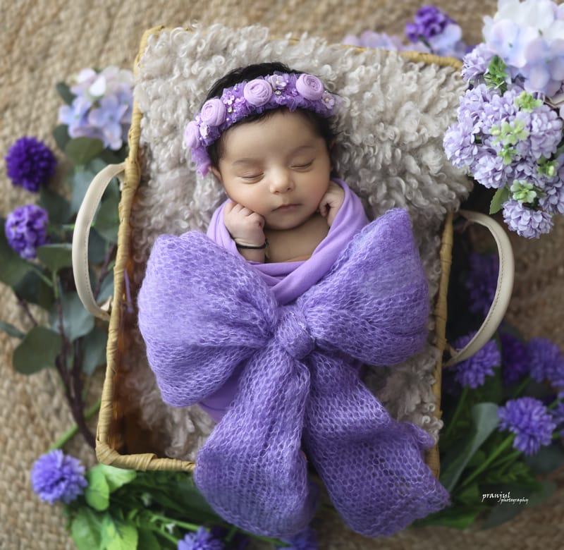 Newborn wrapped snugly in studio session