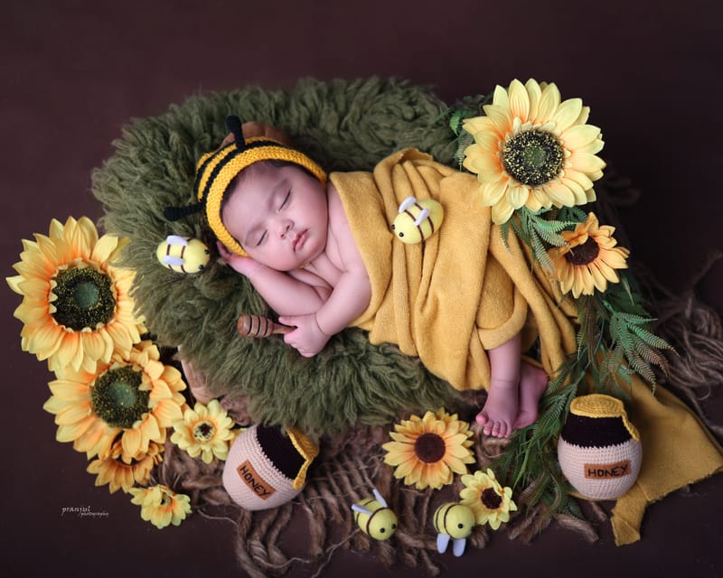 Newborn portrait with warm earth-toned backdrop