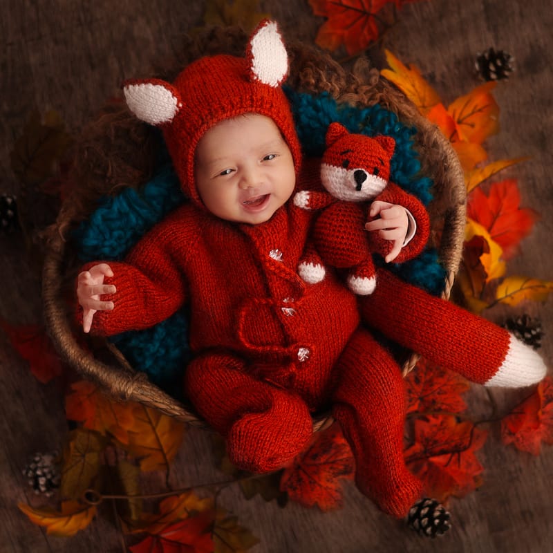 Newborn baby with a knitted bonnet