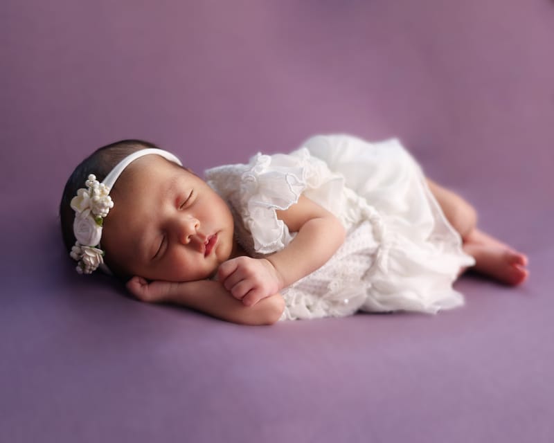Newborn photography session with gentle posing