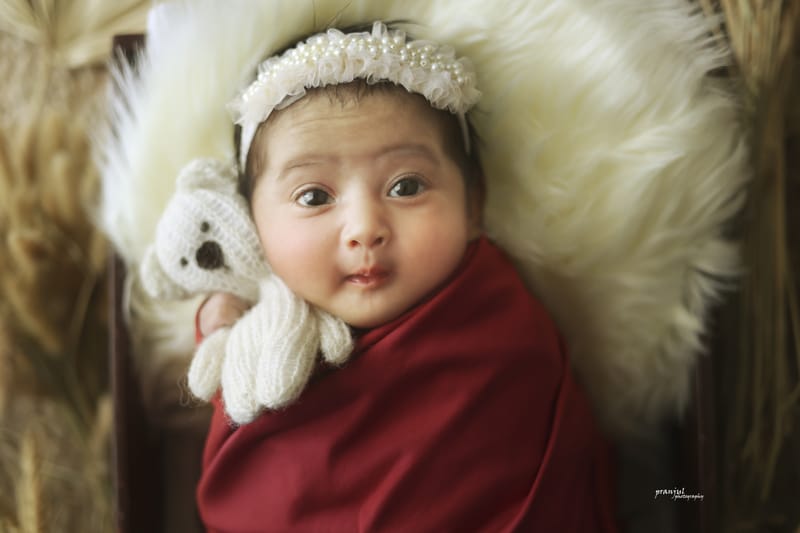 Newborn baby sleeping in a nest-style prop