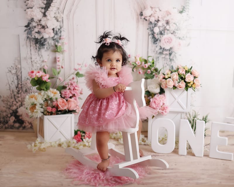 Playful toddler portrait with bright props