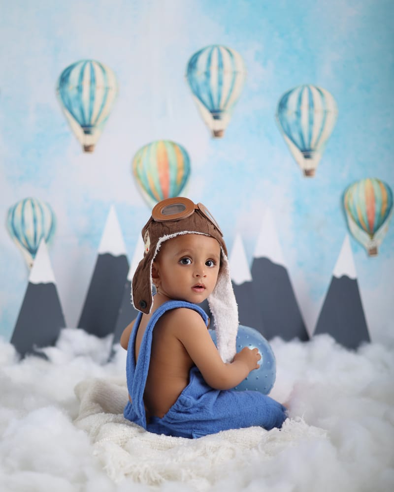 Toddler sitting in a styled miniature scene