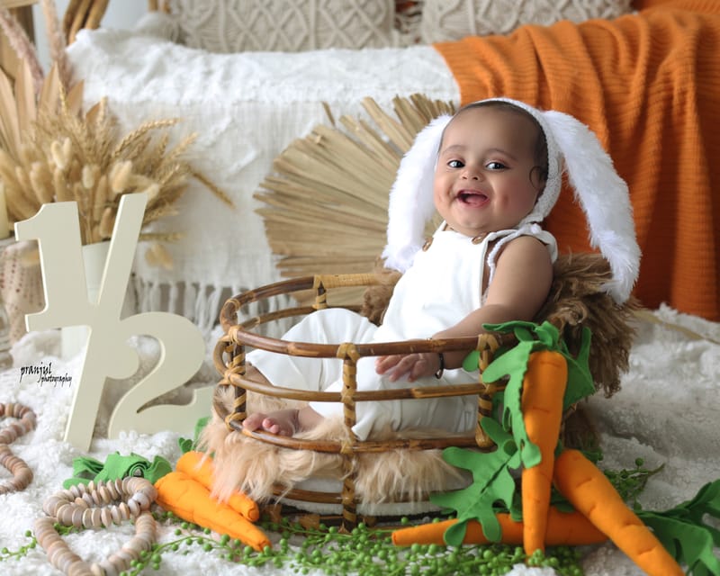 Toddler in a nature-themed studio arrangement